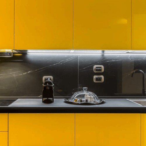 Cucina lineare gialla con top nero